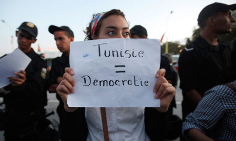 A Tunisian demonstrator holds a sign during a protest against the Islamist Ennahda movement in Tunis