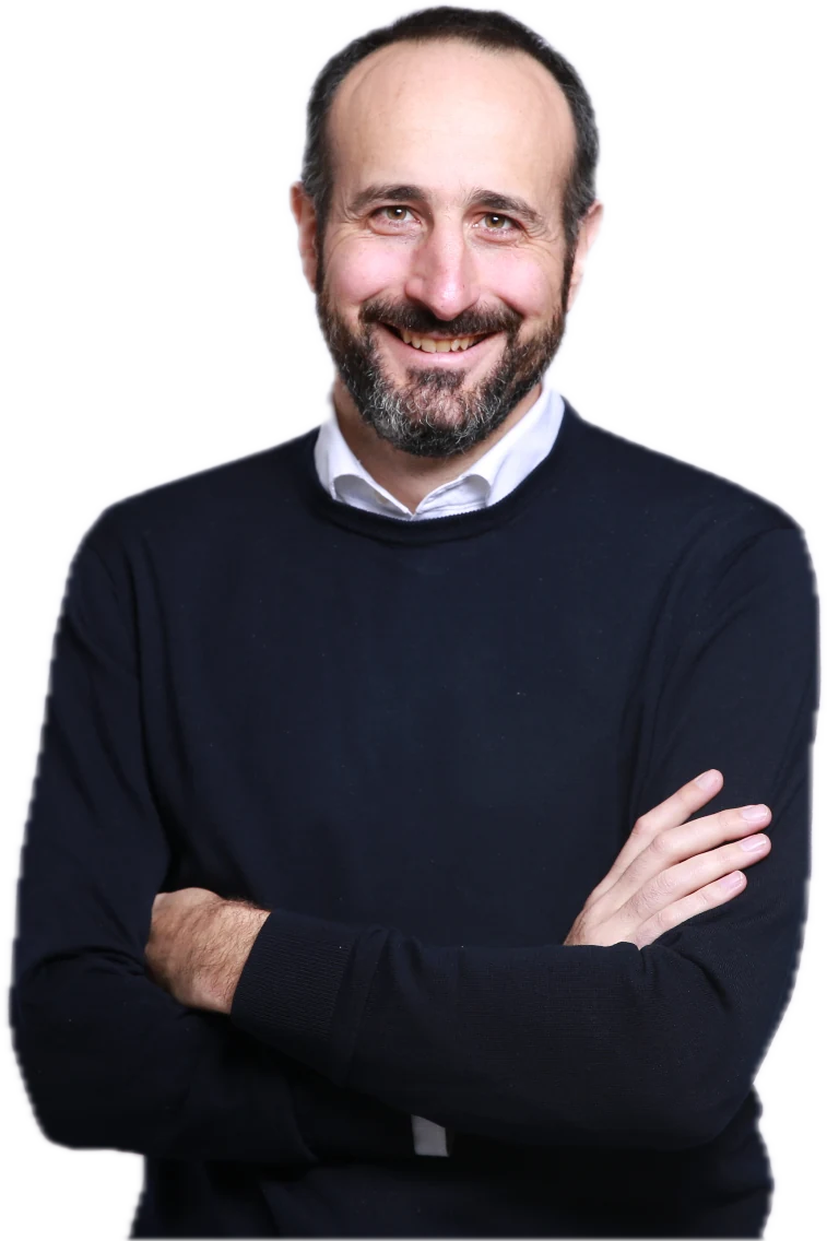 Franck Debane, smiling, arms crossed, in a navy sweater